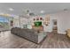 Bright living room boasts wood-look tile, spacious layout, and seamless flow between rooms at 474 Rio De Janeiro Ave, Punta Gorda, FL 33983