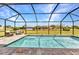 Sparkling screened-in pool features brick pavers and view of the manicured backyard at 474 Rio De Janeiro Ave, Punta Gorda, FL 33983