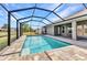 Sparkling screened-in pool features brick pavers and view of the manicured backyard at 474 Rio De Janeiro Ave, Punta Gorda, FL 33983