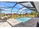 Sparkling screened-in pool features brick pavers and view of the manicured backyard at 474 Rio De Janeiro Ave, Punta Gorda, FL 33983