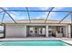Sparkling screened-in pool features brick pavers and view of the manicured backyard at 474 Rio De Janeiro Ave, Punta Gorda, FL 33983