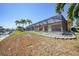 Backyard with enclosed pool, landscaping and canal view with palm trees at 490 Via Esplanade, Punta Gorda, FL 33950