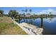 Backyard with canal view, dock and boat lift with boat on lift at 490 Via Esplanade, Punta Gorda, FL 33950