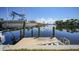 Backyard with canal view, dock and boat lift with boat on lift at 490 Via Esplanade, Punta Gorda, FL 33950
