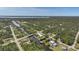 An aerial view showcasing houses on a canal, near intersecting streets and lush landscape at 552 Mccabe St, Port Charlotte, FL 33953