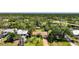 Aerial view of a home on a canal, surrounded by lush trees and foliage at 552 Mccabe St, Port Charlotte, FL 33953