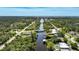 An aerial view of a waterfront community featuring access to a canal and lush landscaping at 552 Mccabe St, Port Charlotte, FL 33953