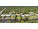 Aerial view of houses on a canal with lush landscaping, near roads and forest at 552 Mccabe St, Port Charlotte, FL 33953