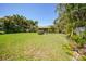 Lush green backyard featuring well-maintained lawn and mature trees at 552 Mccabe St, Port Charlotte, FL 33953