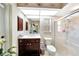 Well-lit bathroom with glass shower, tile floor, toilet, and wood vanity at 552 Mccabe St, Port Charlotte, FL 33953