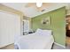 Comfortable bedroom featuring a green accent wall and a ceiling fan at 552 Mccabe St, Port Charlotte, FL 33953