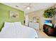 Cozy bedroom with green accent wall, white dresser, and nautical-themed decor at 552 Mccabe St, Port Charlotte, FL 33953