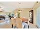 Bright dining room features a round table, elegant chandelier, and natural light from a nearby window at 552 Mccabe St, Port Charlotte, FL 33953
