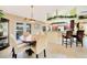 Dining room with an elegant table and chairs, complemented by a view of the kitchen and outdoor scenery at 552 Mccabe St, Port Charlotte, FL 33953
