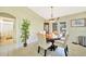 Dining room featuring tile floors, glass table with 6 chairs, and views of the backyard at 552 Mccabe St, Port Charlotte, FL 33953