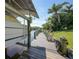A boat lift is on a dock with multiple chairs for relaxing while viewing the waterfront canal at 552 Mccabe St, Port Charlotte, FL 33953