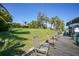 Dock on the waterfront includes multiple chairs, tropical vegetation, and a manicured lawn at 552 Mccabe St, Port Charlotte, FL 33953