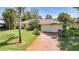 Charming home featuring a brick driveway and attached two-car garage at 552 Mccabe St, Port Charlotte, FL 33953
