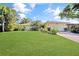 Inviting single-story home with a lush green lawn and mature landscaping at 552 Mccabe St, Port Charlotte, FL 33953
