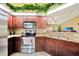 Cozy kitchen featuring stainless steel appliances, ample counter space, and wood cabinets at 552 Mccabe St, Port Charlotte, FL 33953