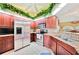 Stylish kitchen featuring wood cabinets, stainless steel appliances, and granite countertops at 552 Mccabe St, Port Charlotte, FL 33953