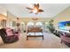 Comfortable living room with a ceiling fan, ample seating, and a large window for natural light at 552 Mccabe St, Port Charlotte, FL 33953