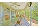 The enclosed patio includes glass table, wicker furniture and an enticing view to the landscaped backyard at 552 Mccabe St, Port Charlotte, FL 33953