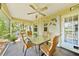 Enclosed patio featuring wicker furniture, tile flooring, and ceiling fan for comfortable outdoor living at 552 Mccabe St, Port Charlotte, FL 33953