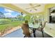 Enclosed patio boasting a glass table, wicker furniture and a view of the manicured lawn at 552 Mccabe St, Port Charlotte, FL 33953