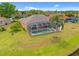 Aerial view featuring screened-in pool and golf course views at 624 Planters Manor Way, Bradenton, FL 34212