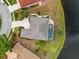 Overhead view of home with screened lanai, swimming pool, landscaping, and waterfront at 624 Planters Manor Way, Bradenton, FL 34212