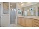 Bathroom with a sink, vanity and a glass enclosed shower with tiled walls at 624 Planters Manor Way, Bradenton, FL 34212