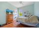 Cozy bedroom features natural light, hardwood floors, and a ceiling fan at 624 Planters Manor Way, Bradenton, FL 34212