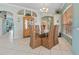 Bright dining room featuring a glass-top table and wicker chairs, with a decorative cabinet at 624 Planters Manor Way, Bradenton, FL 34212