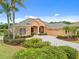 Charming home featuring manicured landscaping, a spacious driveway, and a two-car garage, enhancing curb appeal at 624 Planters Manor Way, Bradenton, FL 34212