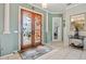 Welcoming foyer featuring tile flooring, elegant columns, and ornate double doors, creating a grand entrance at 624 Planters Manor Way, Bradenton, FL 34212