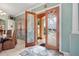 Elegant foyer featuring custom double doors, tile flooring, and views into the dining area, creating a grand entry at 624 Planters Manor Way, Bradenton, FL 34212