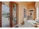 Close-up of the ornate front doors, decorative bench and tiled entry way, adding to the home's character at 624 Planters Manor Way, Bradenton, FL 34212