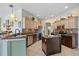 Open kitchen area with granite counters, stainless steel appliances, a center island, and stylish cabinets at 624 Planters Manor Way, Bradenton, FL 34212