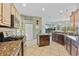 Spacious kitchen featuring granite countertops, a center island, and modern appliances at 624 Planters Manor Way, Bradenton, FL 34212