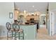 Bright kitchen area with granite countertops, bar seating, stainless appliances and stylish pendant lighting at 624 Planters Manor Way, Bradenton, FL 34212