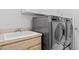 Convenient laundry area with utility sink and modern washer and dryer at 624 Planters Manor Way, Bradenton, FL 34212