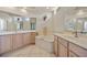 Bright main bathroom featuring dual sinks, spacious vanity, and a soaking tub for relaxation at 624 Planters Manor Way, Bradenton, FL 34212