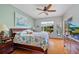 Main bedroom with wood floors, a ceiling fan, and a serene view of the outdoors at 624 Planters Manor Way, Bradenton, FL 34212
