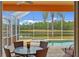 Covered patio features a dining area with views of the pool and pond at 624 Planters Manor Way, Bradenton, FL 34212