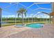 Relaxing screened-in pool and spa area overlooking the pond and nature at 624 Planters Manor Way, Bradenton, FL 34212