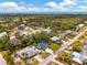 Drone shot of a blue house nestled in a vibrant coastal neighborhood with easy beach access at 1137 Ponderosa Rd, Venice, FL 34293
