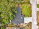 An aerial view of a home with a large tree, green lawn, and long driveway at 1137 Ponderosa Rd, Venice, FL 34293
