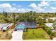 Aerial view of a turquoise home, RV parking, large front yard, and mature trees in a desirable neighborhood at 1137 Ponderosa Rd, Venice, FL 34293