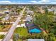 Aerial view of the turquoise home in a quiet neighborhood with lush greenery and nearby streets at 1137 Ponderosa Rd, Venice, FL 34293